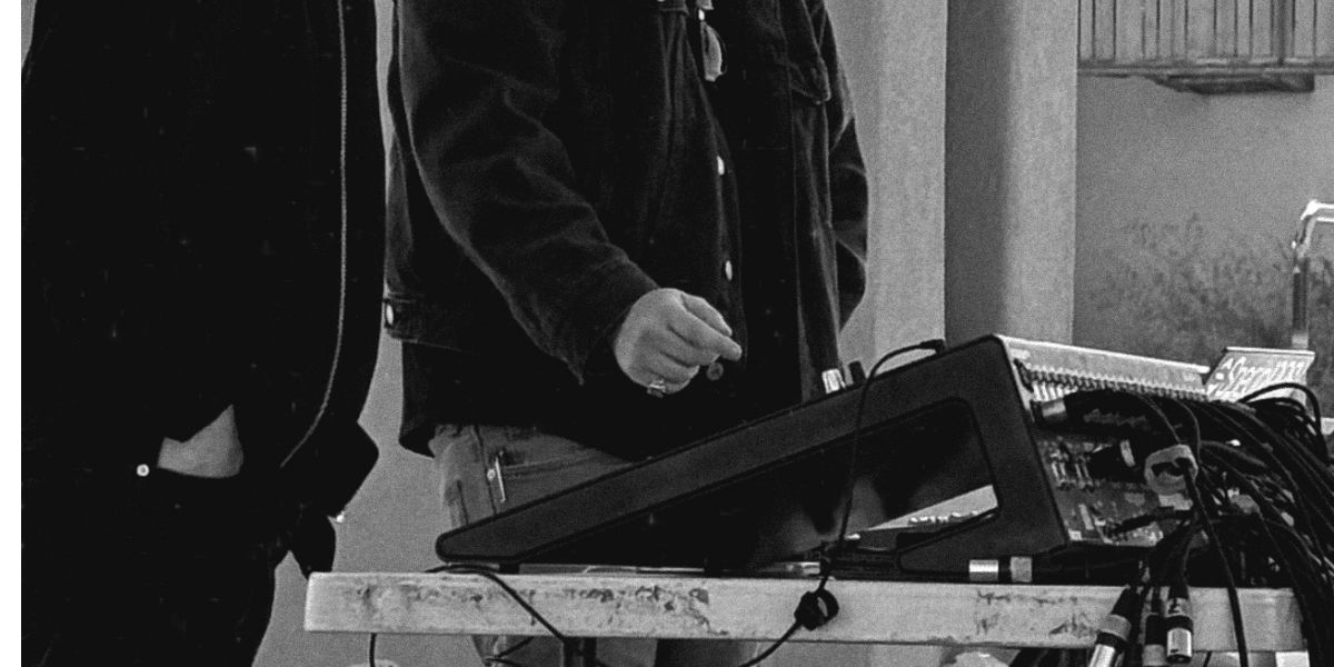 Engineer at recording gear, patio venue. GoatHead Audio venue recording NM.